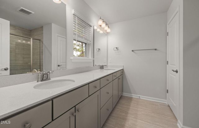 a bathroom with a glass shower door