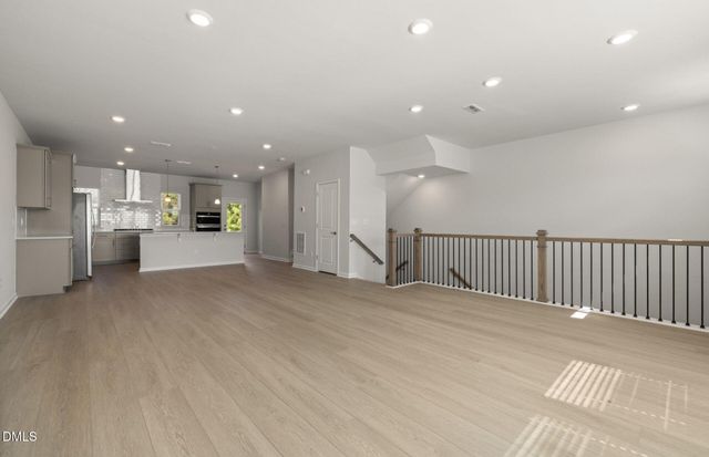 a large kitchen with kitchen island a sink stainless steel appliances and cabinets