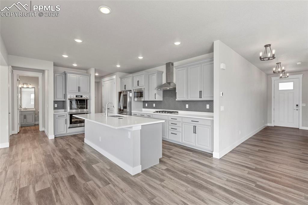 15777 Little Bluestem Road Monument, CO 80132 - Photo 2 of 50 a kitchen with white cabinets and stainless steel appliances