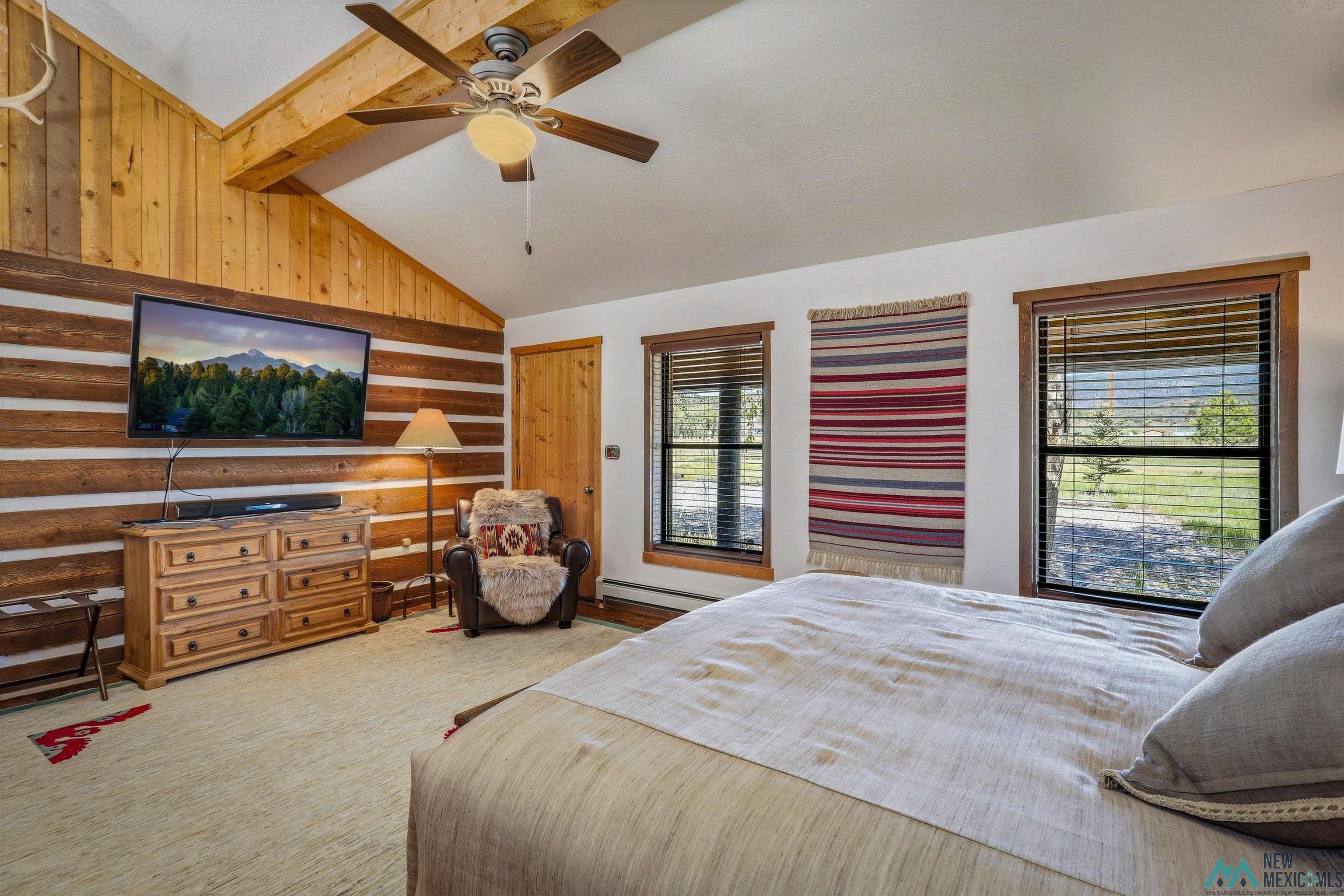 83 Juniper Road Chama, NM 87520 - Photo 25 of 56 Vaulted ceiling with wood paneling and exposed beam