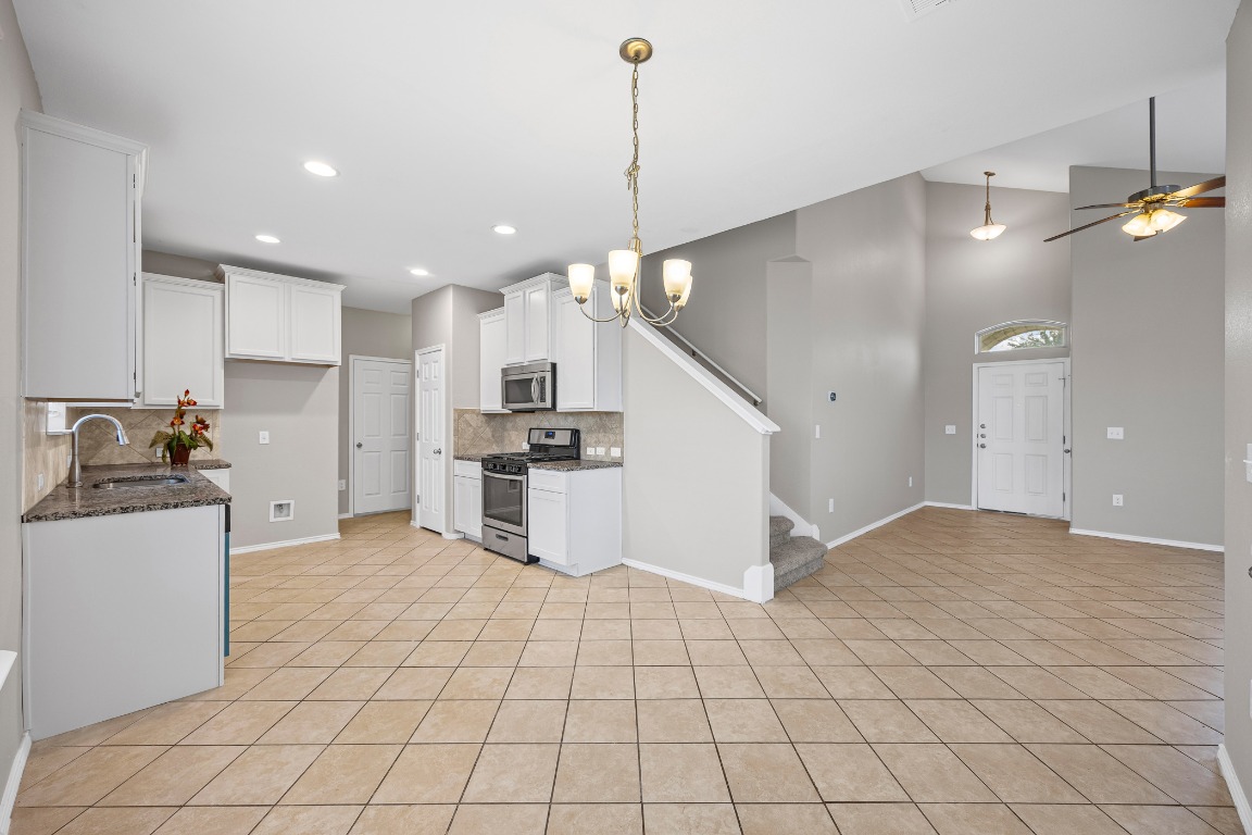 139 Diamondback Cove Buda, TX 78610 - Photo 15 of 15 a view of a kitchen with cabinets and stainless steel appliances