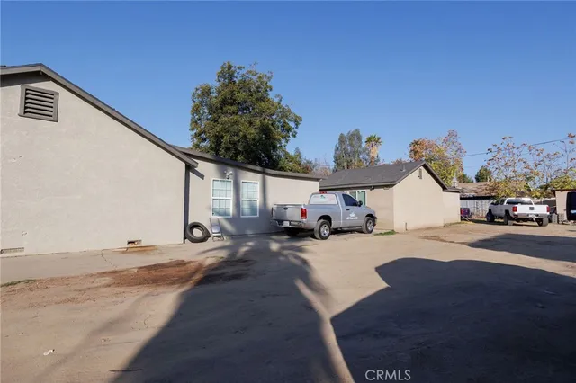 a view of a house with car parked on road
