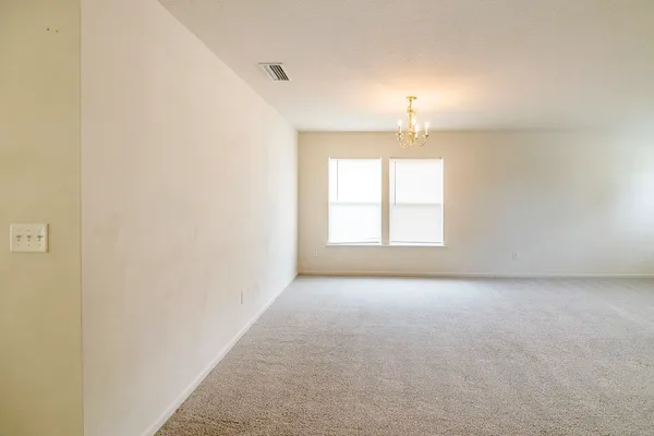 a spacious bathroom with a granite countertop sink and a large window