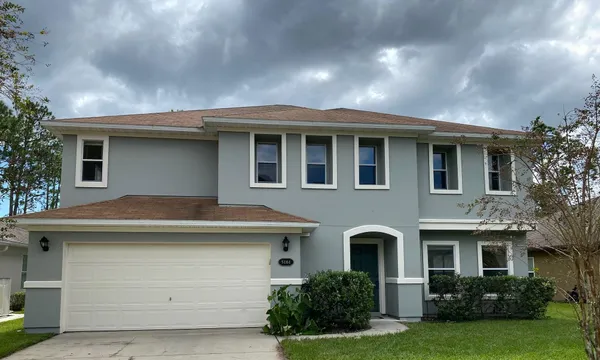 a front view of a house with garden