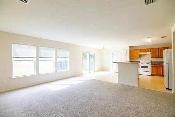 a spacious bathroom with a granite countertop sink a toilet and a shower