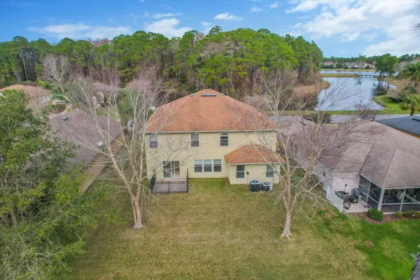 an aerial view of a house with outdoor space patio and swimming pool