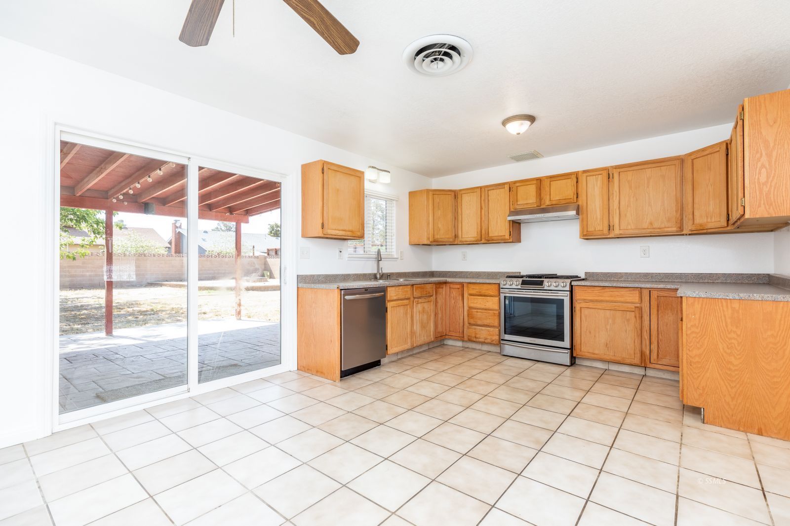 317 Mari Court Ridgecrest, CA 93555 - Photo 9 of 30 a kitchen with stainless steel appliances kitchen island granite countertop a sink a stove top oven a counter space and cabinets