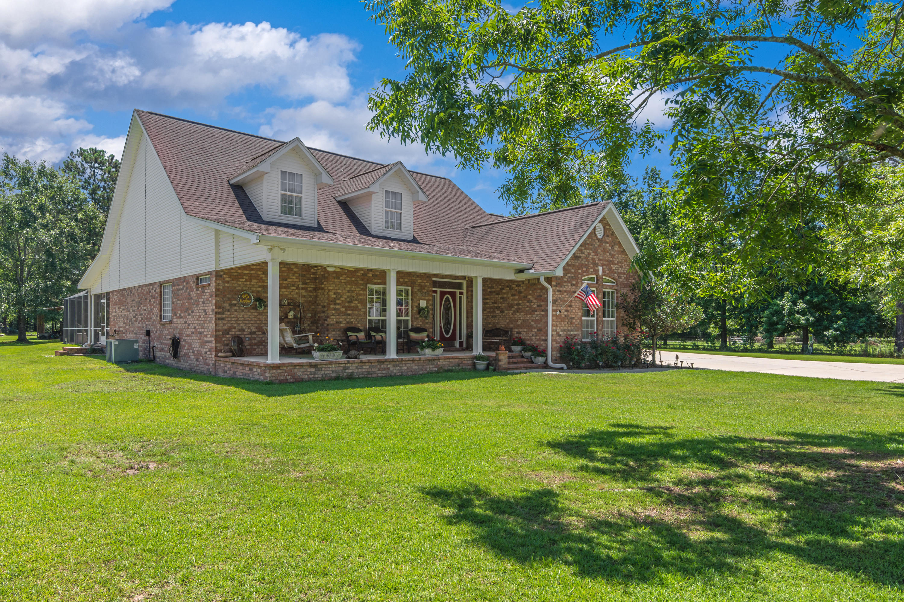 5985 Jack Stokes Road Baker, FL 32531 - Photo 4 of 63 a view of a house with a yard and sitting area
