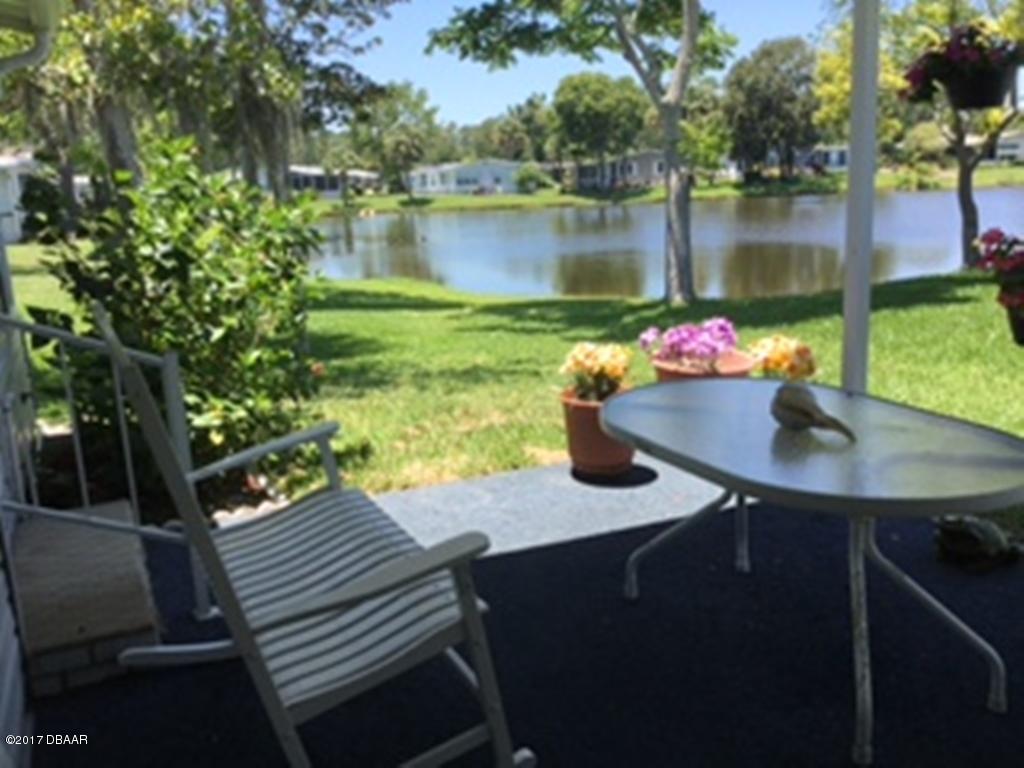 738 Navigators Way Edgewater, FL 32141 - Photo 3 of 16 a view of a lake from a patio