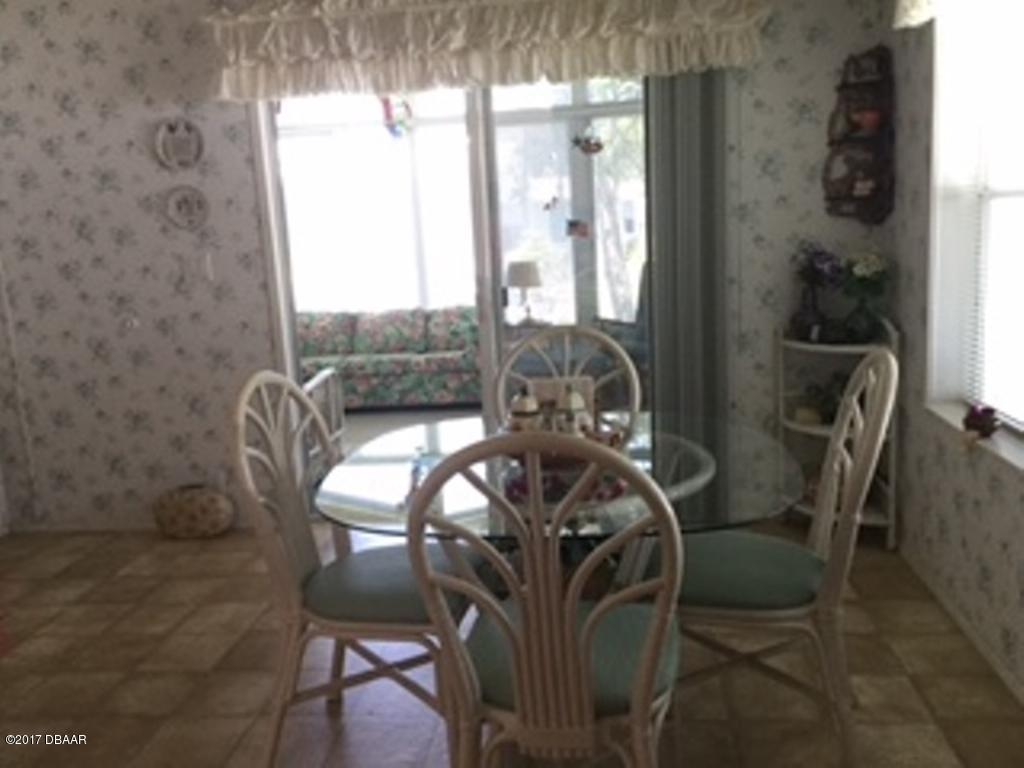 738 Navigators Way Edgewater, FL 32141 - Photo 7 of 16 a view of balcony and dining area with furniture