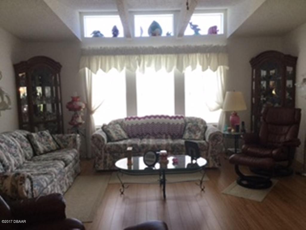 738 Navigators Way Edgewater, FL 32141 - Photo 8 of 16 a living room with furniture and a large window