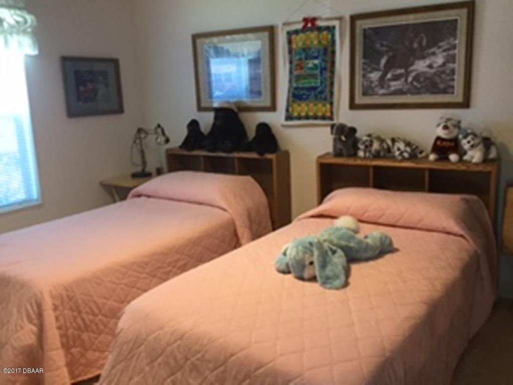 738 Navigators Way Edgewater, FL 32141 - Photo 10 of 16 a bedroom with bed and painting on the wall