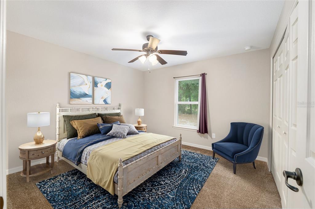 2 Hemlock Loop Drive Ocala, FL 34472 - Photo 21 of 28 a bedroom with bed and a couch