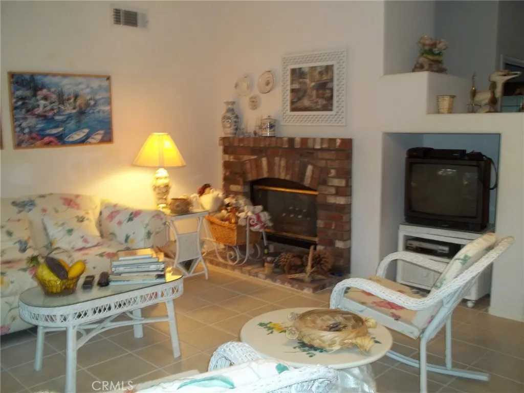1647 Shire Avenue Oceanside, CA 92057 - Photo 7 of 15 a living room with furniture a flat screen tv and a fireplace