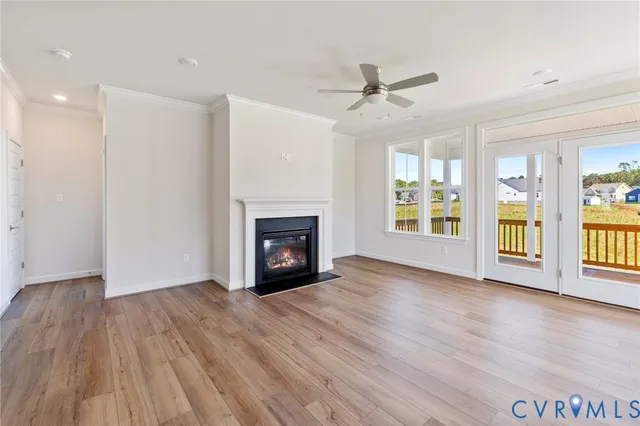a view of an empty room with a fireplace and a window
