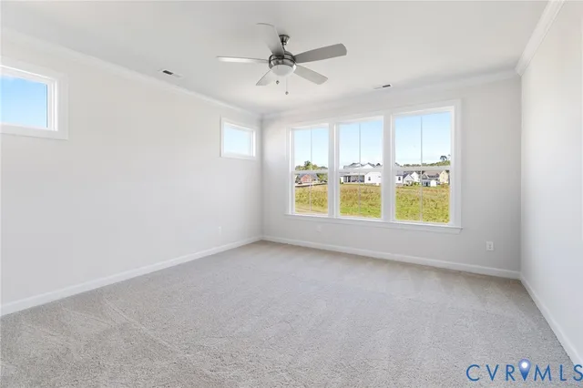 an empty room with a window and ceiling fan