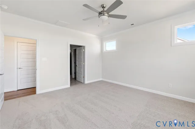 an empty room with fan and windows
