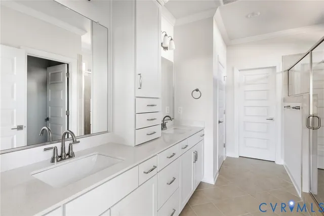 a spacious bathroom with a double vanity sink mirror double and shower