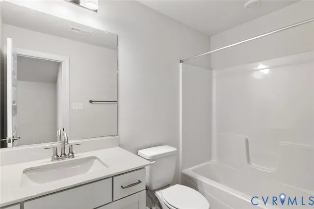 a bathroom with a sink toilet vanity and tub