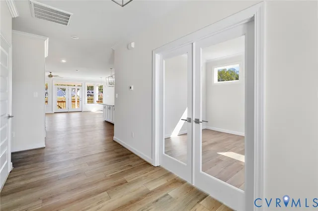 a view of empty room with wooden floor