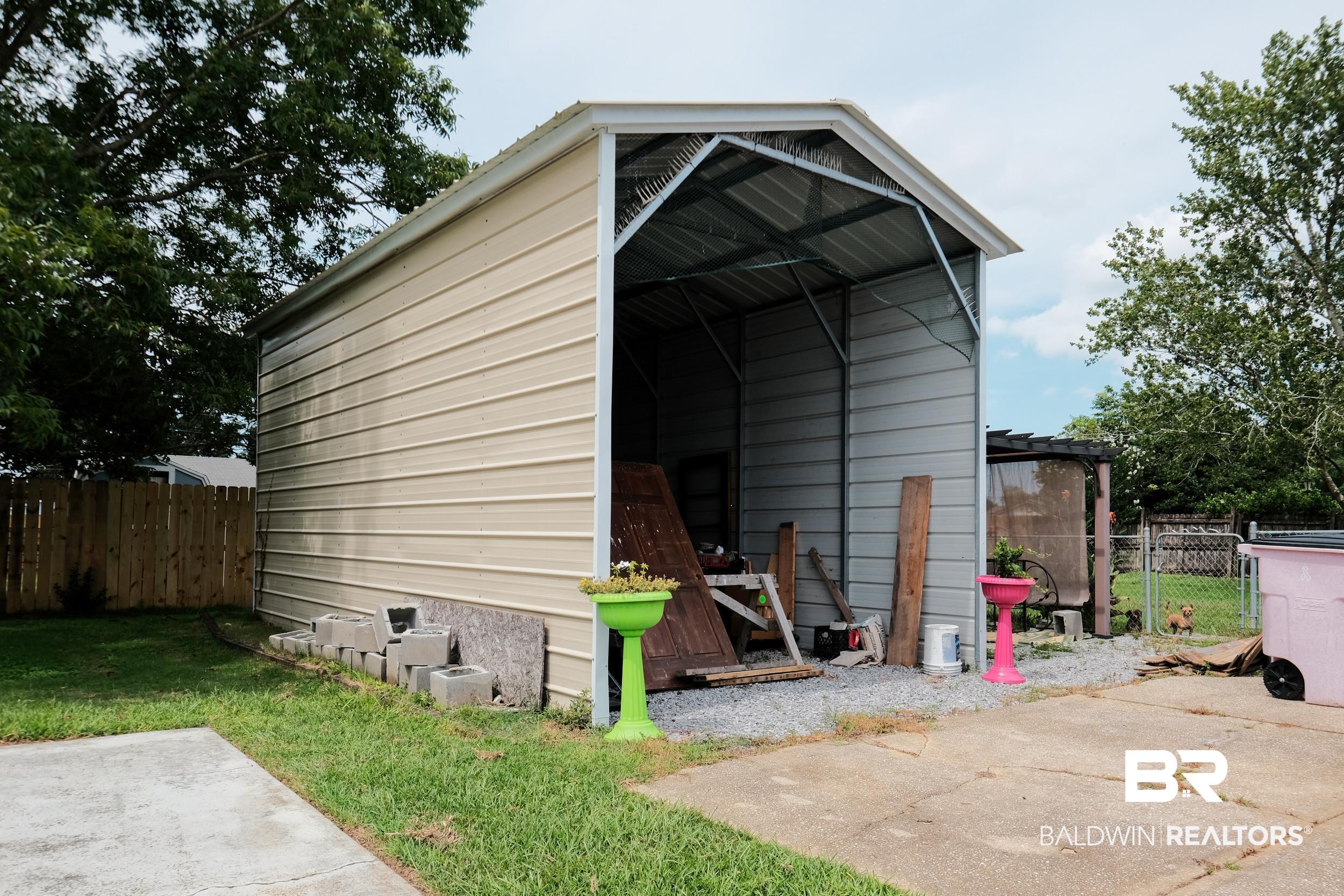 504 Ariel Avenue Foley, AL 36535 - Photo 4 of 33 View of outdoor structure with a yard
