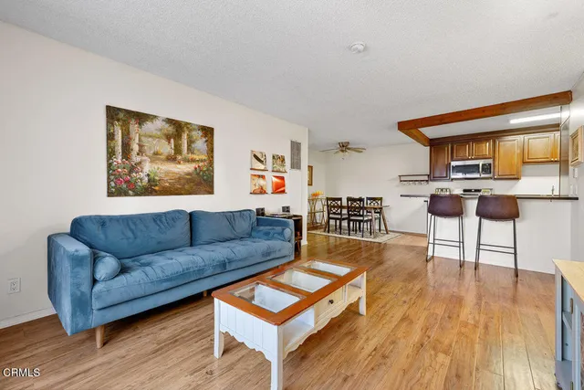 a living room with furniture and a wooden floor