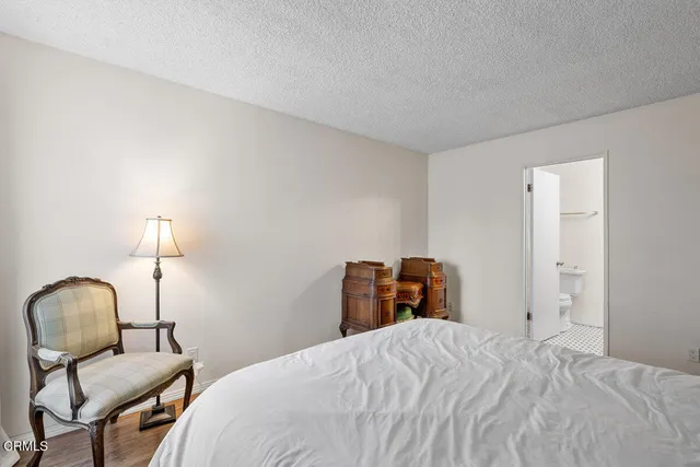 a bedroom with a bed and a chair