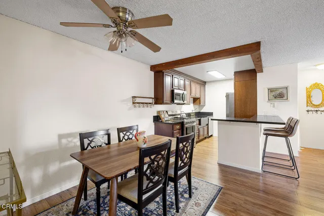 a view of a dining room with furniture and wooden floor