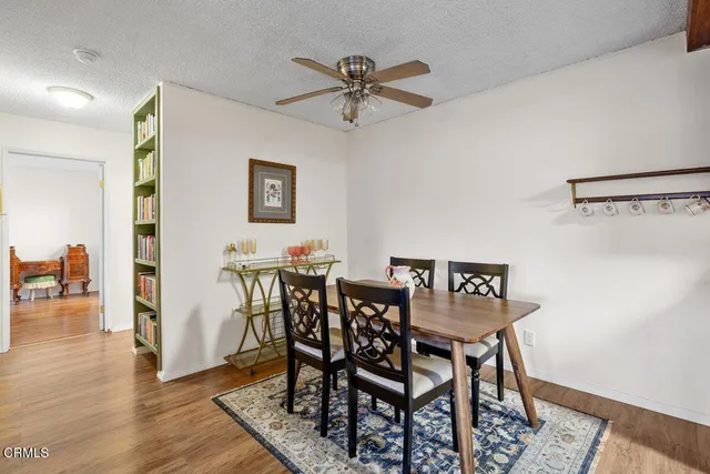a view of a dining room with furniture and wooden floor