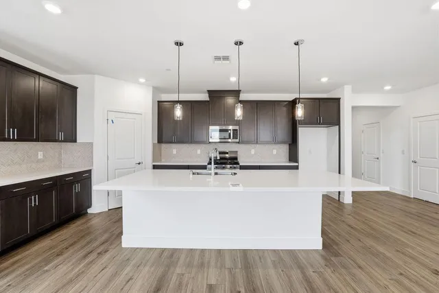 a large kitchen with stainless steel appliances