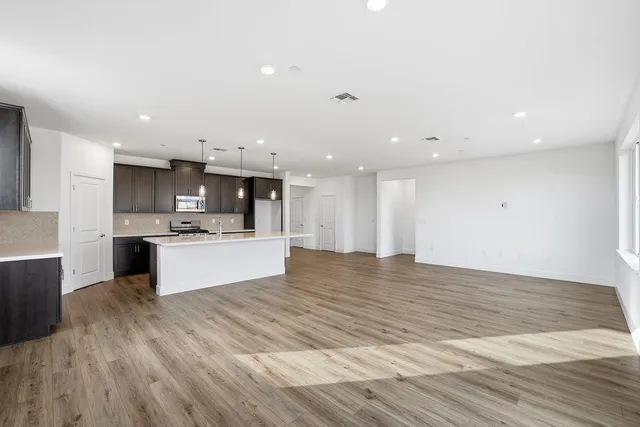 a view of kitchen with kitchen island sink stainless steel appliances and cabinets