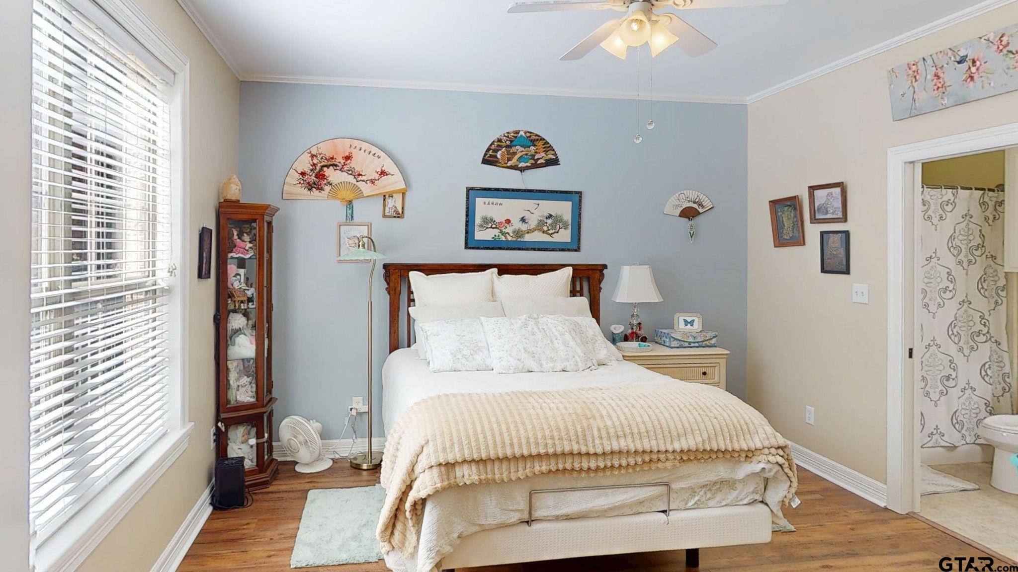 18488 Bluebird Circle Flint, TX 75762 - Photo 27 of 47 a bedroom with a bed and a chandelier