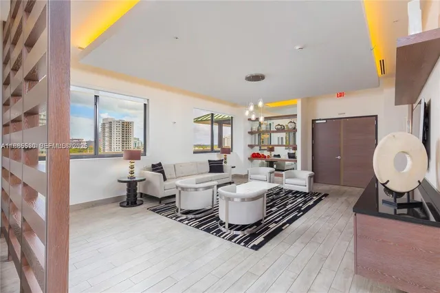 a living room with furniture and a large window