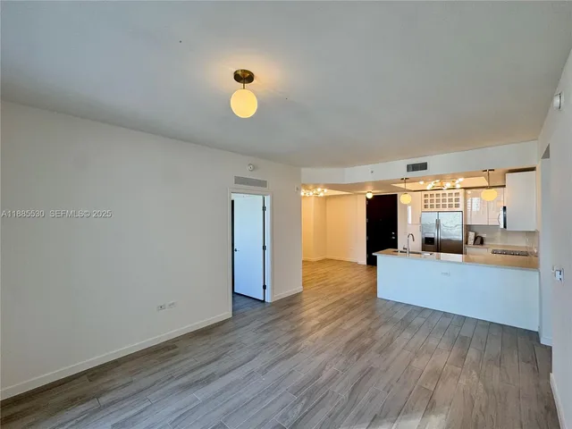 a view of a living room and hardwood floor