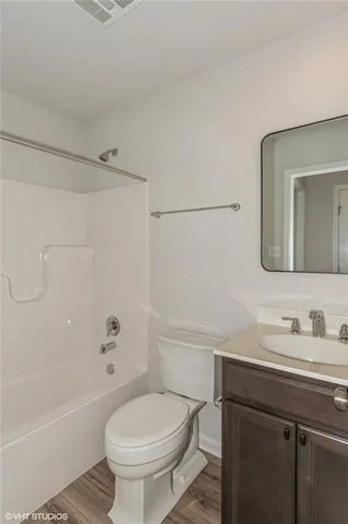 a front view of a building with cars