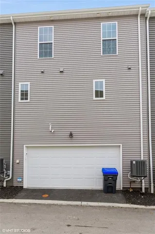 a front view of a house with a road