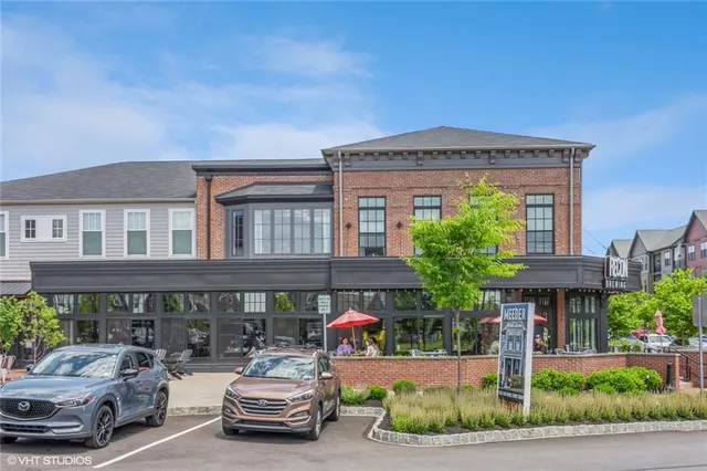 a front view of a building with sitting area