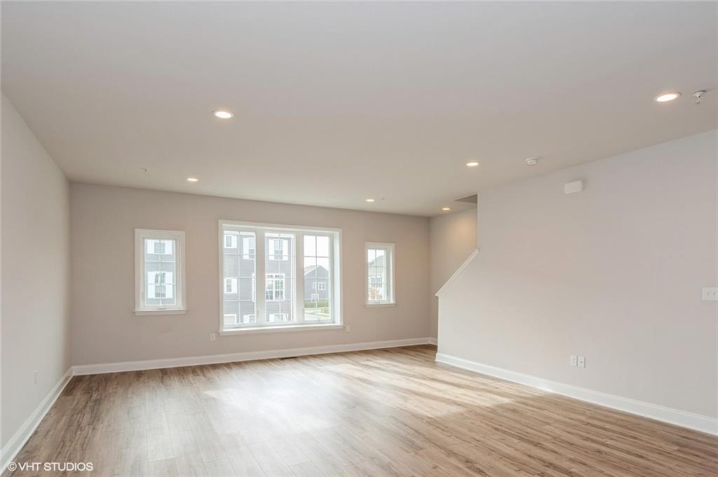 210 Gress Road Cranberry Township, PA 16066 - Photo 7 of 38 a view of an empty room with a window and wooden floor
