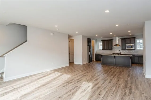 a large white kitchen with a large window
