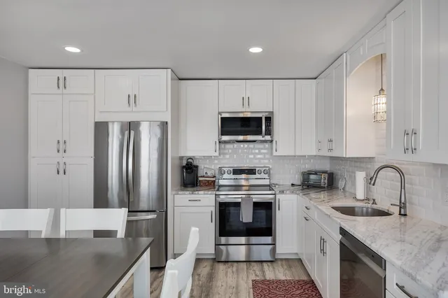 a kitchen with a sink stove and refrigerator