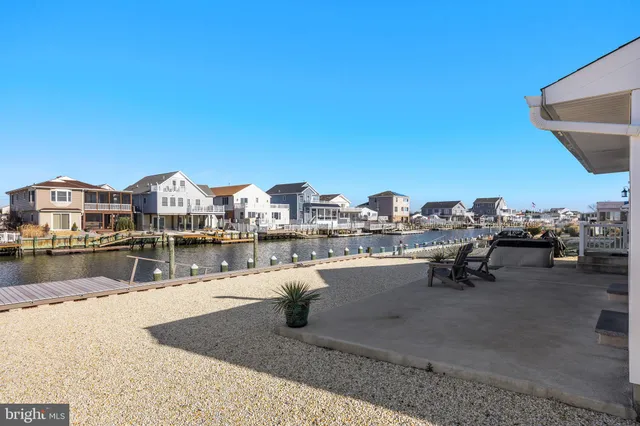 a swimming pool with outdoor seating and lake view