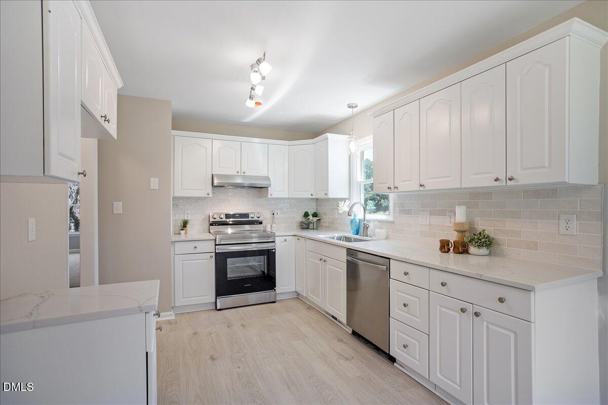 31 Fieldview Court Angier, NC 27501 - Photo 9 of 25 a kitchen with cabinets and stainless steel appliances
