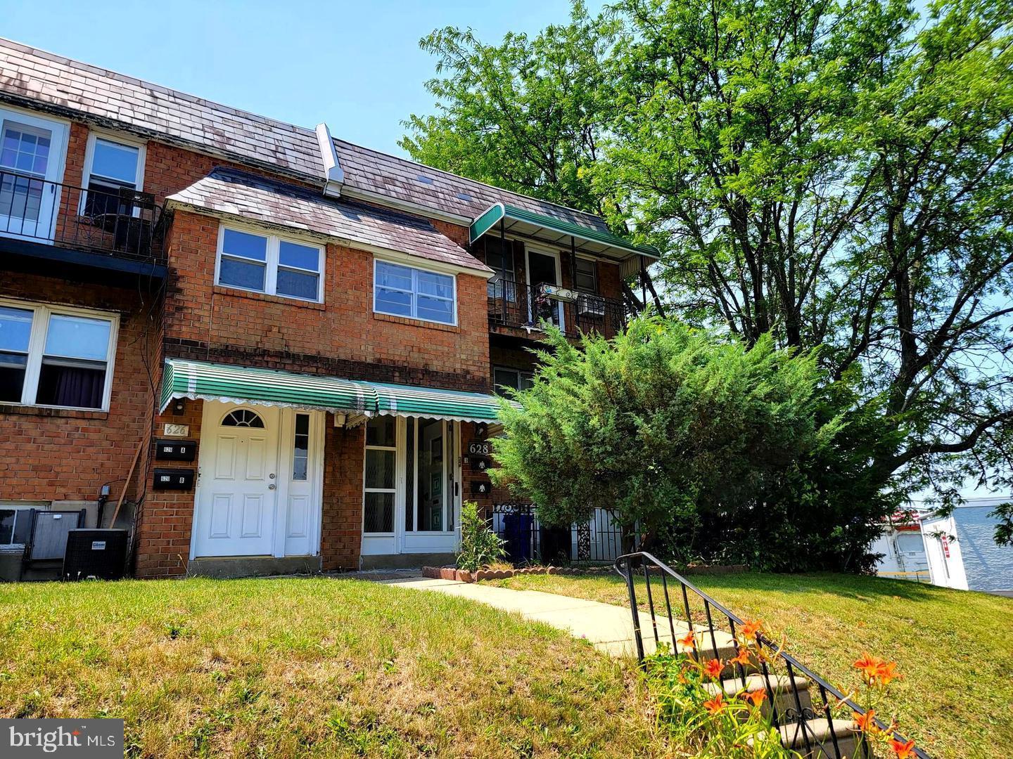 a house view with a sitting space and garden