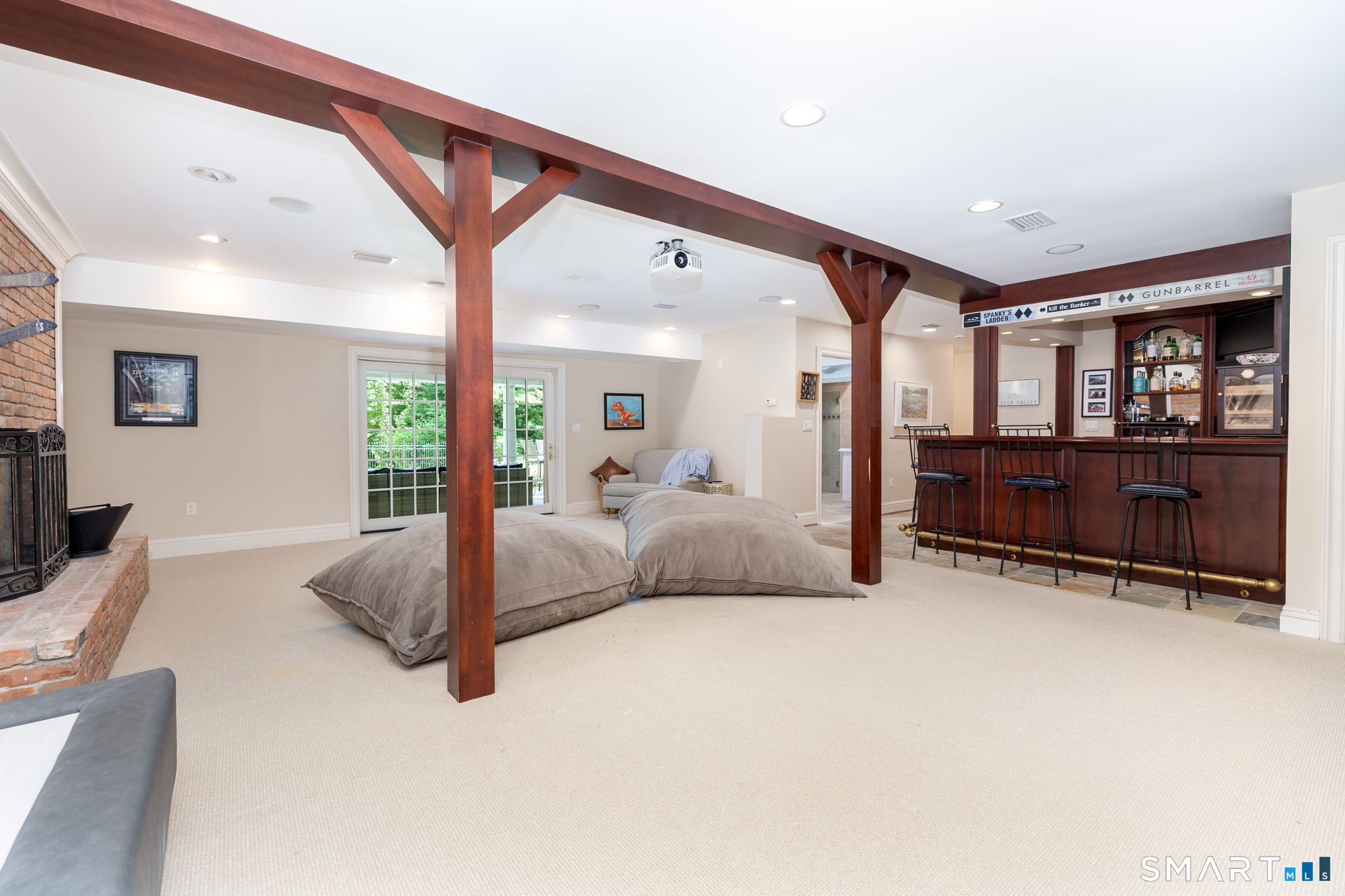 82 Ledyard Road West Hartford, CT 06117 - Photo 34 of 40 Media /rec room has fireplace, bar, and direct access to the lower level patio
