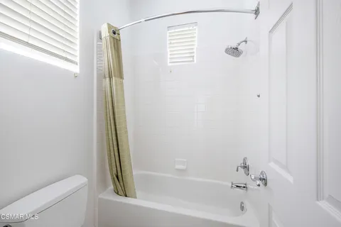 a bathroom with a shower and a toilet