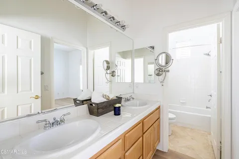 a bathroom with a sink double vanity and a mirror