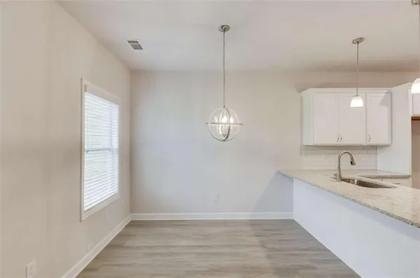 a kitchen with stainless steel appliances granite countertop a sink a stove and a granite counter top