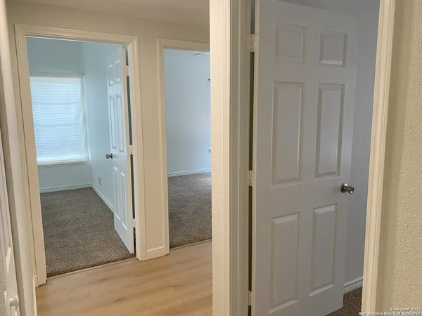 a view of a bathroom from the hallway with toilet