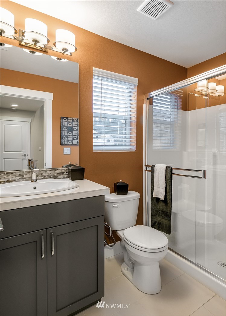 23118 88th Avenue West, Unit 3 Edmonds, WA 98026 - Photo 12 of 31 a bathroom with a toilet sink and mirror