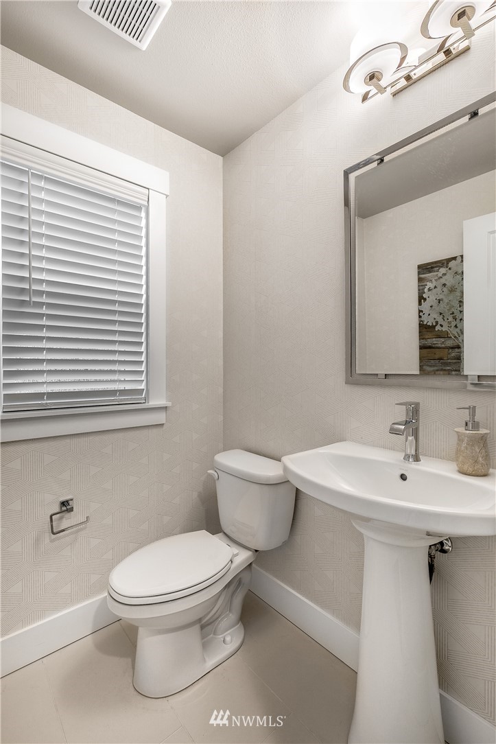 23118 88th Avenue West, Unit 3 Edmonds, WA 98026 - Photo 24 of 31 a bathroom with a toilet a sink and mirror